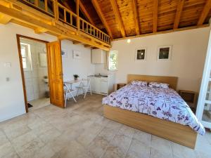 a bedroom with a bed and a kitchen and a table at Villa Insula in Vela Luka