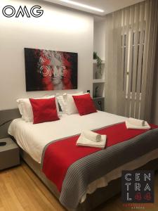 a bedroom with a large bed with red pillows at CentraL44 OMG Casual Suite in Athens