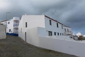 a group of white buildings on a street at Casa na Carrapateira, Aljezur in Carrapateira