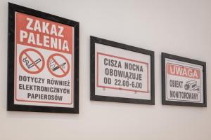 three framed signs hanging on a wall at KRAKOWIAK in Krakow