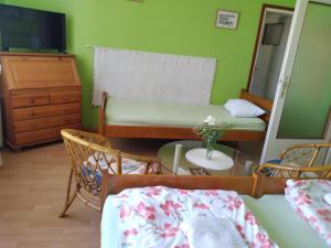 a small room with a bed and a mirror at Hostel Bata in Kanjiža