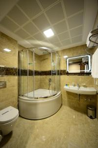 a bathroom with a shower and a toilet and a sink at Grand Bazaar Hotel in Istanbul
