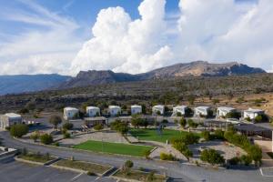 an aerial view of a resort with mountains in the background at Jebel Shams Resort منتجع جبل شمس in Dār Sawdāʼ