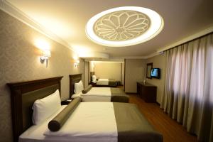Postel nebo postele na pokoji v ubytování Grand Bazaar Hotel