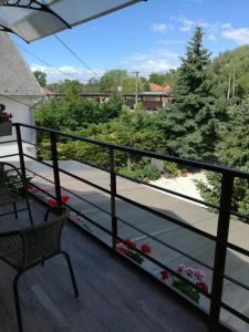 a balcony with a bench and a view of trees at Arapartman in Zamárdi