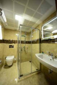 a bathroom with a shower and a sink and a toilet at Grand Bazaar Hotel in Istanbul