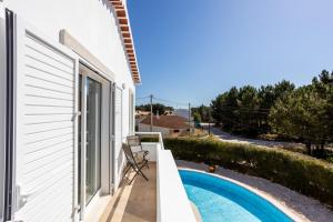 a view from the balcony of a house with a swimming pool at Villa Flavia in Aljezur