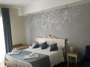 Postel nebo postele na pokoji v ubytování CAVALIERE suite & rooms