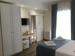 Postel nebo postele na pokoji v ubytování CAVALIERE suite & rooms