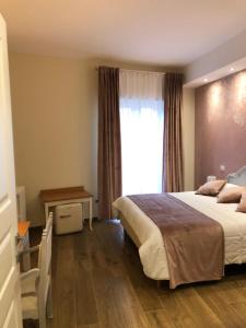 Postel nebo postele na pokoji v ubytování CAVALIERE suite & rooms