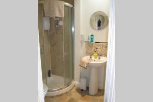 a bathroom with a shower and a sink at Spire View Apartment in Salisbury