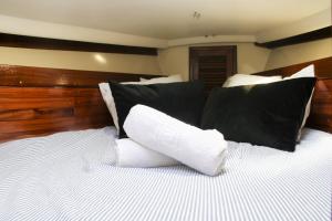 a bed with black and white pillows on it at Charming Liberté with private parking in Vila Nova de Gaia