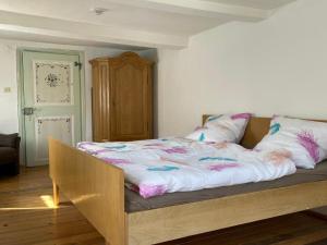 a bed with pink and white sheets and pillows on it at Sauerland-Relax in Schmallenberg