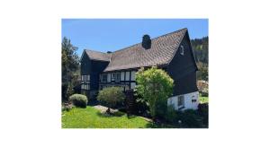 a black and white house with a yard at Sauerland-Relax in Schmallenberg