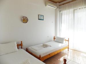 Postel nebo postele na pokoji v ubytování Hotel Sgouridis