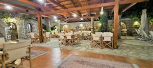 a patio with tables and chairs in a building at Kastro Hotel in Spetses