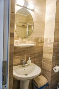 a bathroom with a sink and a mirror at Vila Gladiola in Eforie Nord +23 photos