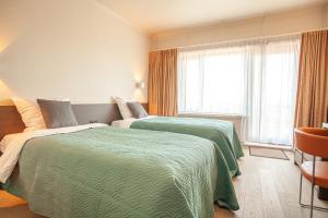 Voodi või voodid majutusasutuse Hotel Monaco Zeebrugge Beach by Rikas Hotels toas