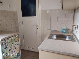 a kitchen with a sink and a counter top at Nafsika in Ammouliani