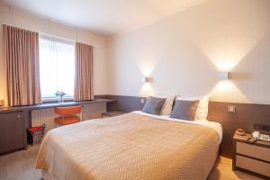 Voodi või voodid majutusasutuse Hotel Monaco Zeebrugge Beach by Rikas Hotels toas