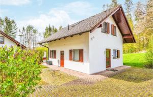 a white house with red doors and a yard at Ferienhaus 4 In Kirchheim in Kirchheim