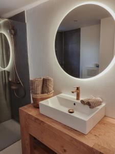 a bathroom with a white sink and a mirror at Casa Vista Bonita in Port de Soller
