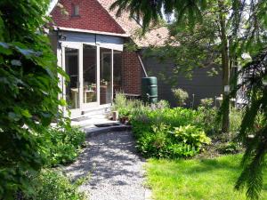 a house with a pathway leading to the front door at B&B 't Gezellig Huizeke in Zoersel +31 photos