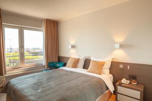 Voodi või voodid majutusasutuse Hotel Monaco Zeebrugge Beach by Rikas Hotels toas