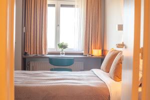 Voodi või voodid majutusasutuse Hotel Monaco Zeebrugge Beach by Rikas Hotels toas