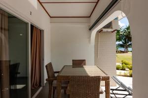 a dining room with a table and chairs on a balcony at HideAway in Praslin