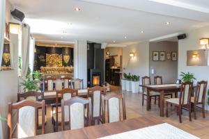 a restaurant with wooden tables and chairs and a dining room at Willa Dana in Wisła