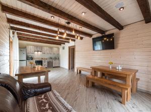 a living room with a couch and a table at Villa Grace in Oryavchyk