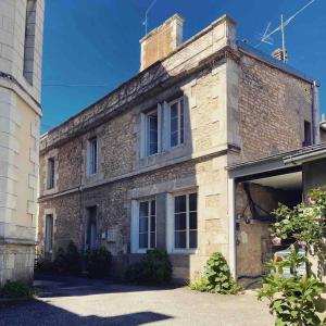 an external view of a brick building with a garage at Maison Saint Louis in Poitiers