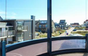a balcony with a view of a street and buildings at The Blue Whale in Bergen aan Zee +14 photos