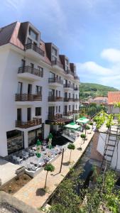 a hotel with tables and chairs in front of a building at Grand Hotel Pogradec in Pogradec