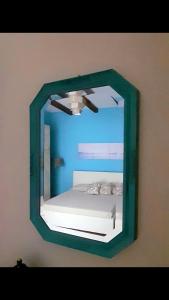 a mirror on a wall with a bed in it at A casa dell’amica mia in San Nicola Arcella