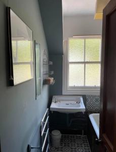 a bathroom with a white sink and a window at The Dornie in Dornie