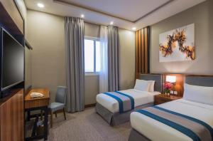Ένα ή περισσότερα κρεβάτια σε δωμάτιο στο Myrtle Hotel - Al Sahafa