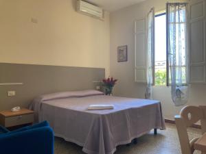 Postel nebo postele na pokoji v ubytování Hotel Verdesolemare