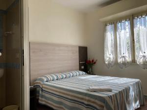 Postel nebo postele na pokoji v ubytování Hotel Verdesolemare