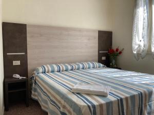 Postel nebo postele na pokoji v ubytování Hotel Verdesolemare