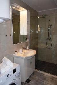 a bathroom with a sink and a shower at Two-Bedroom House with Shared Pool in heart of Seget in Trogir