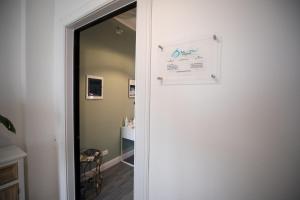 una puerta que conduce a una habitación con un cartel en la pared en Bru Rooms, en Peschiera del Garda