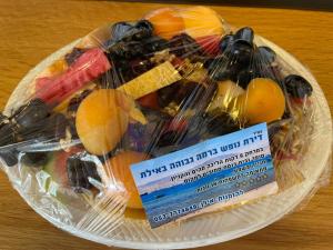 a plastic container filled with fruit and vegetables on a table at דירות נופש וג'קוזי באילת - אילן vip in Eilat +83 photos