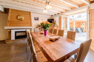 a dining room with a wooden table and a fireplace at St Lary/Vignec: Les 3 Flocons in Vignec