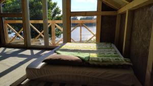 a bed sitting inside of a room with a window at Top Chill party kucice apartmani in Belgrade +13 photos