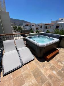a hot tub sitting on top of a patio at Andros 4 All Seasons Villas & Suites in Andros
