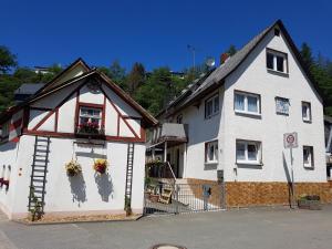una casa blanca con flores en la parte delantera en Ferienwohnung Jansen "Zwei" en Bad Schwalbach