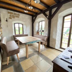 a dining room with a wooden table and chairs at Fewo WAFFENKAMMER im Rittergut Leppersdorf bei Dresden für 7 Personen in Leppersdorf