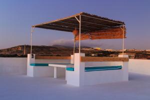 a picnic table with a canopy on top of a building at Villa Baya in El Haouaria